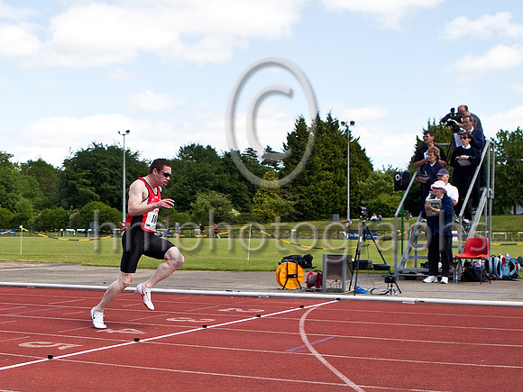 Jason Smith of City of Derry Spartans crosses the line to break the NI 100m record in 10:32 seconds - FT8E0655-e3a4j