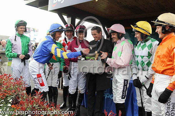 Davy Russell adds a flower to AP McCoy's presentation