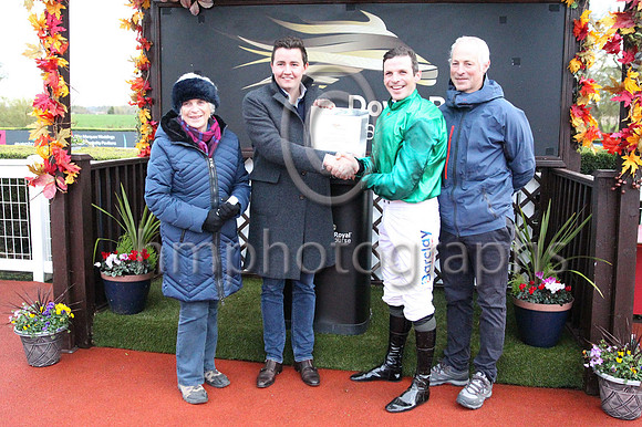 Edith Crwaford and Ian McGahey, Sales Director of Workpal, the Race Sponsor after Carnfunnock trained by Stuart Crawford and ridden by his brother Ben won the Workpal Flat Race on Day 1 of the Ladbrok