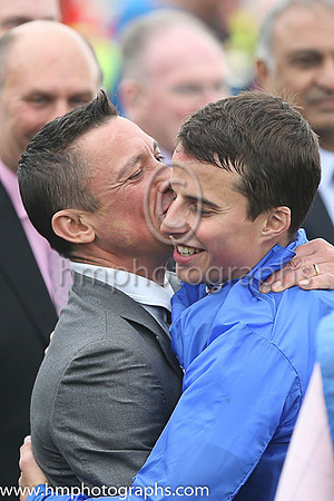 Frankie Dettori embraces William Buick jockey of Jack Hoppd after winning the Dubai Duty Free Irish Derby at the Curragh
