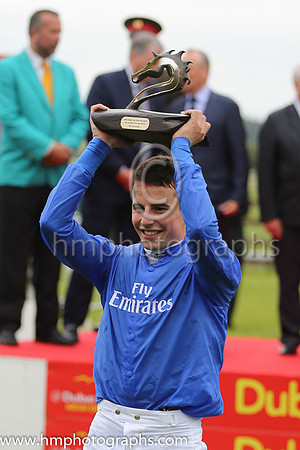 William Buick holds the trophy aloft after winning the Dubai Duty Free Irish Derby at the Curragh