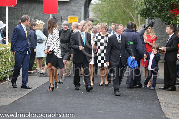 Owners and trainers and friends enter the parade ring at the Irish derby at the Curragh