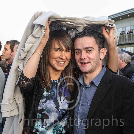 Sinead and Martin Mulholland from Magheralin shelter from the rain at the Down Royal Boxing Day Race Meeting - CU2D5595-e2