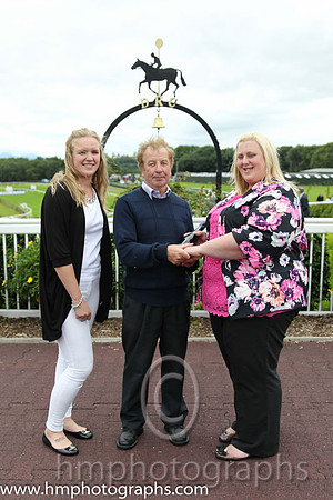 Sarah Miller and Lauren Burns present prize to winning trainer at Downpatrick. Sarah and Lauren from County Durham have been on a tour of irish Racecourses visiting Leopardstown, Tipperery, Kilbeggan