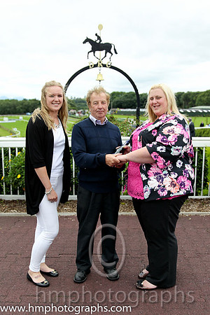 Sarah Miller and Lauren Burns present prize to winning trainer at Downpatrick. Sarah and Lauren from County Durham have been on a tour of irish Racecourses visiting Leopardstown, Tipperery, Kilbeggan