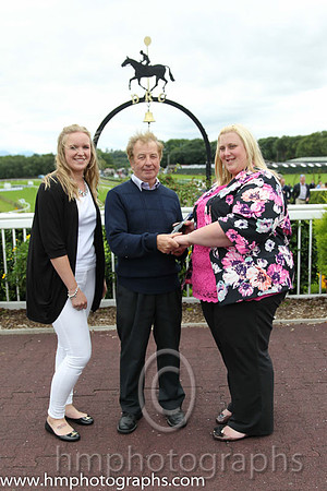 Sarah Miller and Lauren Burns present prize to winning trainer at Downpatrick. Sarah and Lauren from County Durham have been on a tour of irish Racecourses visiting Leopardstown, Tipperery, Kilbeggan