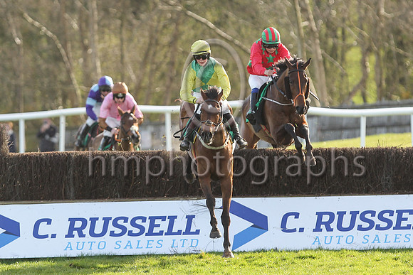 Shantou Show (yellow and green diabolo) ridden by Ms C L McGoldrick jump the last fence in the lead before to win the Boardsmill Sires Maiden Hunters Steeplechase at the Randox Ulster National Meeting