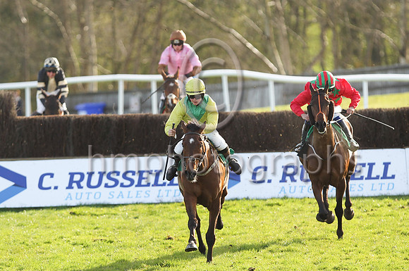 Shantou Show (yellow and green diabolo) ridden by Ms C L McGoldrick in the lead after jumping the last fence to win the Boardsmill Sires Maiden Hunters Steeplechase at the Randox Ulster National Meeti