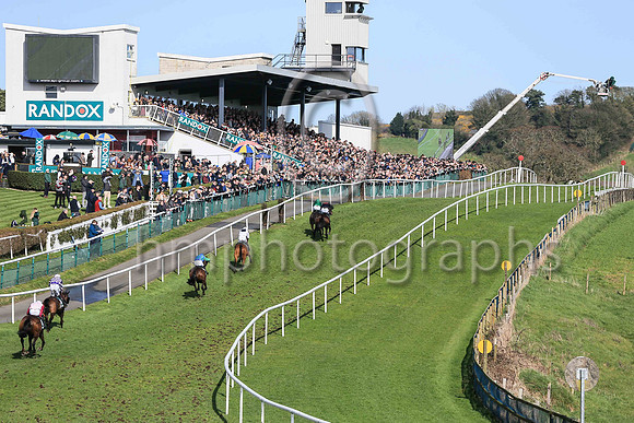 Malina Girl (green) ridden by Keith Donoghue climb the hill in the lead to go on to win the Randox Ulster National Handicap Steeplechase at DOnwpatrick on 2nd April 2023. Maina Girl is trained by Gavi