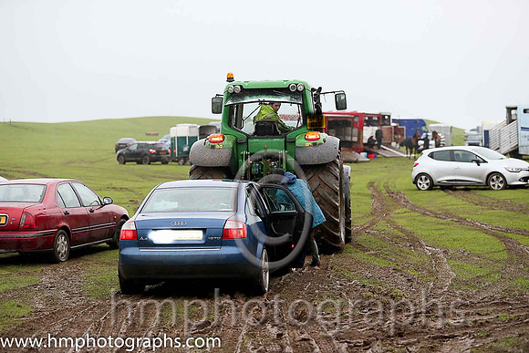 Car stuck in the mud being towed out