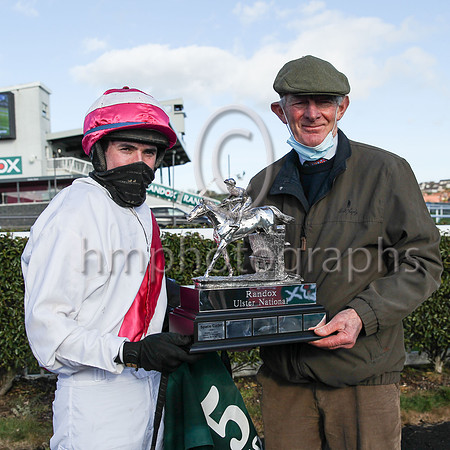 Jockey D O'Keeffe  and trainer Arthur Moore with the R andox trophy after their horse Fag an Bealach won the R andox Ulster National H andicap Steeplechase at Downpatrick on Sunday. Fag an Bealach is