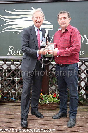 Mark Bingley of Louis Roederer Chanpagne present the trophy to Eddie Murray representing the winning owner TheyDontknow Syndicate after The Louis Reoderer Handicap of 12,000 Euro at Down Royal