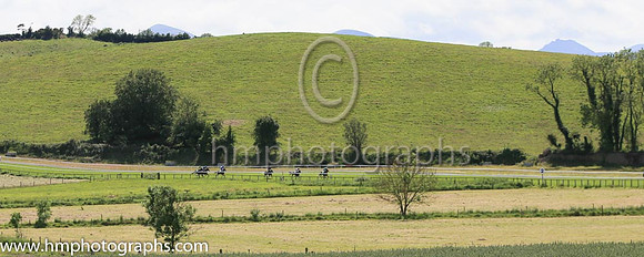 Racing at Downpatrick on 12th June 2022 with the Mountains on Mourne in the background - Slieve Donard on the left