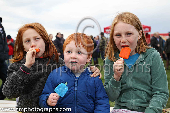 Maddy, Frankie and Gracie McNally enjoy their lollypops at The Route Point-To-Point Steeplechases at Portrush