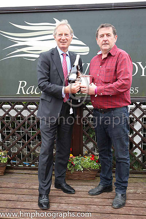 Mark Bingley of Louis Roederer Chanpagne present the trophy to Eddie Murray representing the winning owner TheyDontknow Syndicate after The Louis Reoderer Handicap of 12,000 Euro at Down Royal