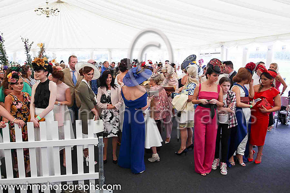 Girls wait expectantly for the results of the Best Dressed Competions at Downpatrick Ladies Day Races