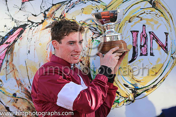 Jack Kennedy jockey holding the trophy after Outlander won the JNWINE.COM Champion Chase at Down Royal.