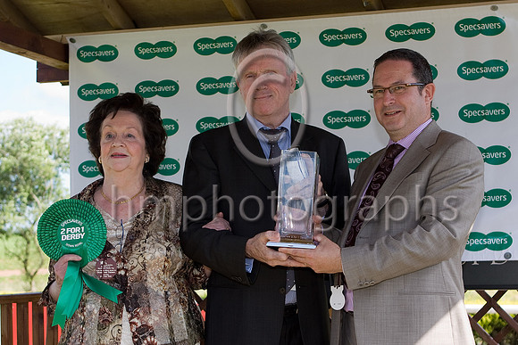 Celtic Dane wins the Specsavers 2 for 1 Derby at Down Royal - Specsavers Ann Street store direstor David Maguire presents the trophy to David Bennan son of the Owner Eileen Brennan - IMG_0392-e3a4j