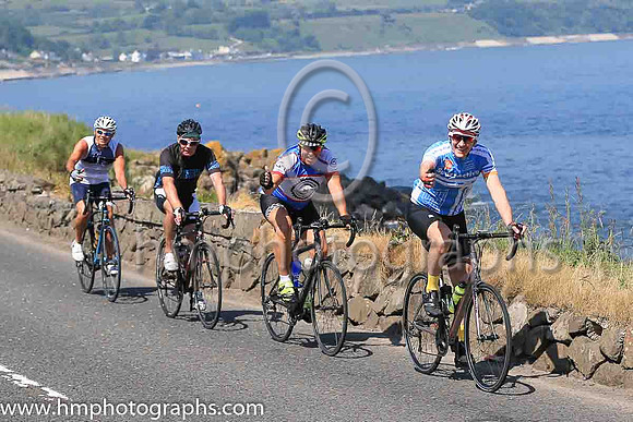 Cyclists on the Antrim Coast Road at Ballygally Head in Northern ireland