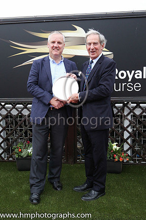 Joe Osborne, representing owners Godolphin receiving the trophy from David Lindsay , Lord Lieutenant of Down after Twilight Payment and jockey Kevin Manning won Her Majesty's Plate Stakes (Listed Race