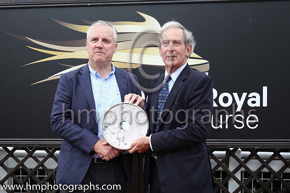 Joe Osborne, representing owners Godolphin receiving the trophy from David Lindsay , Lord Lieutenant of Down after Twilight Payment and jockey Kevin Manning won Her Majesty's Plate Stakes (Listed Race