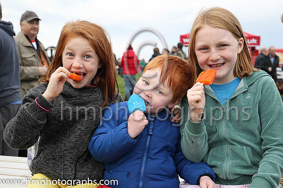 Maddy, Frankie and Gracie McNally enjoy their lollypops at The Route Point-To-Point Steeplechases at Portrush