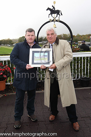 Chairman of the Board of Directors of Downpatrick Racecourse Peter Stewart (right) making a presentation to the winning trainer for 2018, Gordon Elliott