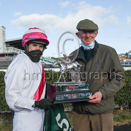 Jockey D O'Keeffe  and trainer Arthur Moore with the R andox trophy after their horse Fag an Bealach won the R andox Ulster National H andicap Steeplechase at Downpatrick on Sunday. Fag an Bealach is