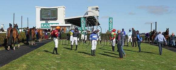 Jockeys and trainers in the parade ring at Downpatrcisk Racecourse