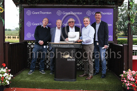 Neil Taylor Grant Thornton Partner presenting to owners Jimmy Owens and Vincent Kennedy (second left)