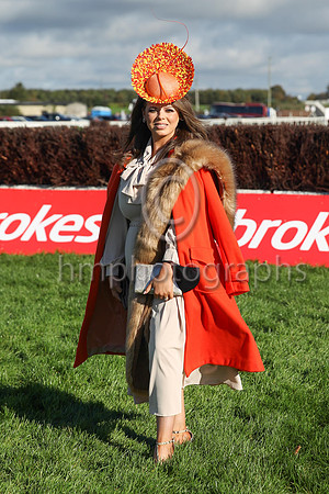 An apprehensive Sarah Foy from County Mayo poses for the camera as she crosses the race course to enter the Down Royal complex. Sarah won the Dr Emma Clinics Best Dressed Competition on Ladies Day at