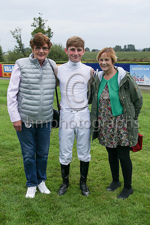 Pauline Conlon and Mairead Price from Dublin representing the owners of Magi Gal with jockey Cillian McConnell in the parade ring before the Grant Thornton Handicap at Down Royal on 2nd September 2022