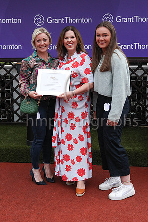 Louise Kelly Partner from Grant Thornton presents a memento to Ber Fahey wife of trainer Peter Fahey after Sign From Above won the Grant Thornton Handicap at Down Royal on 2nd September 2022. Also in