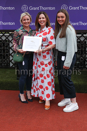 Louise Kelly Partner from Grant Thornton presents a memento to Ber Fahey wife of trainer Peter Fahey after Sign From Above won the Grant Thornton Handicap at Down Royal on 2nd September 2022. Also in