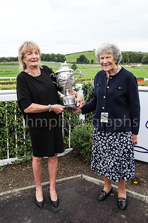 Mrs Marian Cave with the Caughoo Perpetual Trophy  and Mrs William Brownlow MBE Patron of Downpatrick Racecourse at the course on Monday 30th August 2021