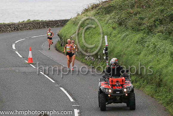 The leading women round Ballygally Head in the Antrim Coast Half Marathon