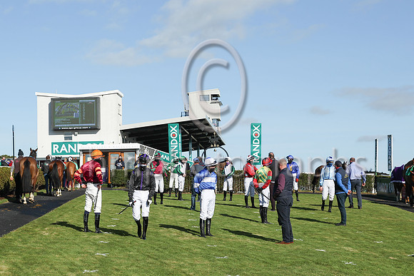 Jockeys  and trainers social distance in the parade ring at Downpatrick Racecourse on Sunday
