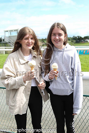 Julie Thompson and Katie Morrow enjoying an ice cream at Downpatrick Races on 12th June 2022