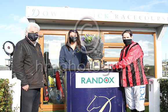Peter Stewart, the chairman of the Downpatrick Racecourse  and Ruth Morrison , Hospitality Manager present flowers to Rachael Blackmore at the R andox Ulster Meeting on Sunday at Downpatrick to Racha