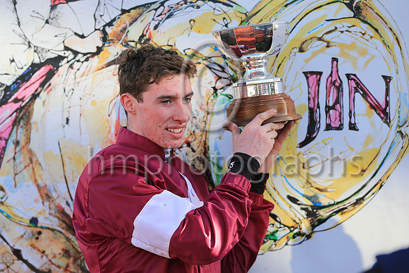 Jack Kennedy jockey holding the trophy after Outlander won the JNWINE.COM Champion Chase at Down Royal.