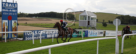 01st Slippery Serpent and Mr B O'Neill ( 2 , black, white cross sash ) Trainer - E J O'Grady , Owner - Mrs E J O'Grady crosses the line to win the Flat Race at Downpatrick Races