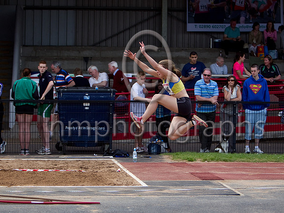 A Superman fan looks on in support as a competitor takes to the air in the Women's Triple Jump Competition - CU2D0068-e23a4j