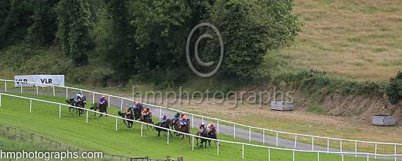 Racing down the hill in the second race at The Family Fun Raceday at Downpatrick Race Course on Wednesday 13th July 2022.