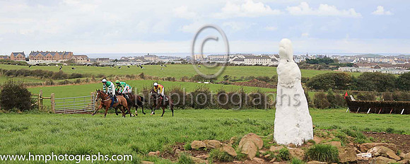 Horses at the Route Point-To-Point Steeplechases at Portrush pass the The White Wife, an ancient stone. <br/><br/>http://www.irishmegaliths.org.uk/derry.htm