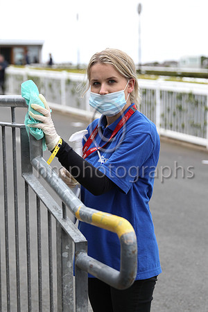 Papiyeja Banach from the Concept Group disinfecting the railings at DOwnpatrick Race Course