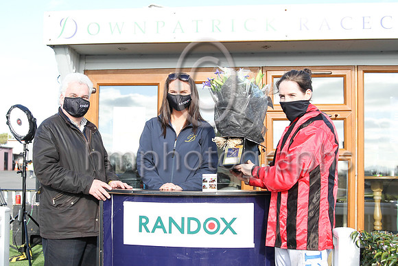 Peter Stewart, the chairman of the Downpatrick Racecourse  and Ruth Morrison , Hospitality Manager present flowers to Rachael Blackmore at the R andox Ulster Meeting on Sunday at Downpatrick to Racha